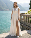 Long white wedding dress with sensual slit, long sleeves with pearls